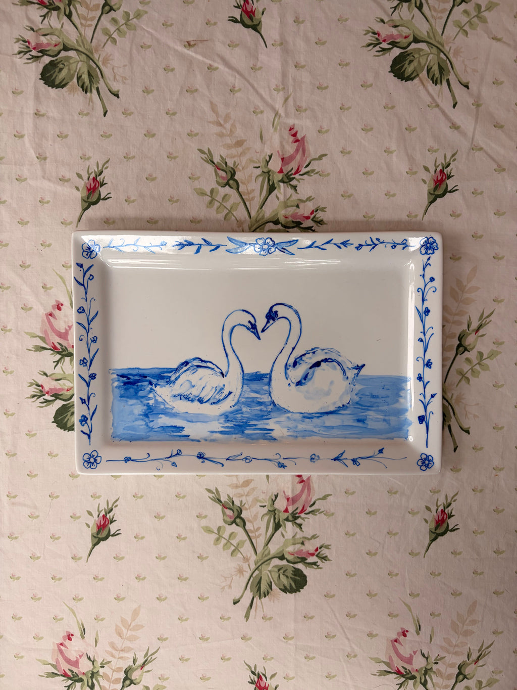 hand painted blue swans on a white large ceramic platter tray plate with a whimsical dainty floral motif border